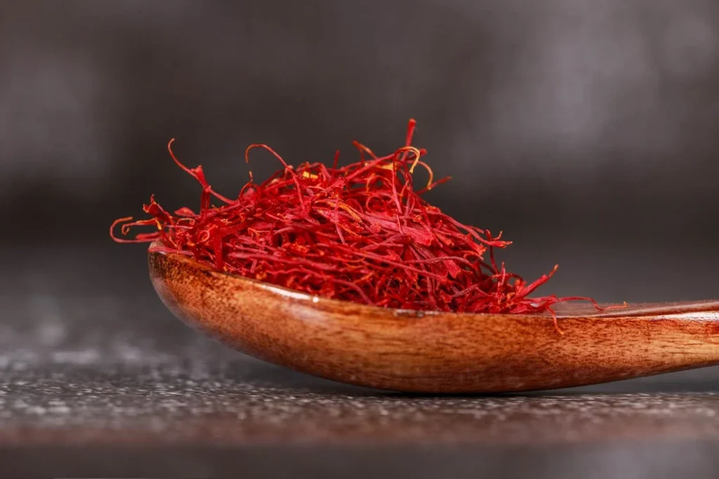 kashmiri saffron in a wooden spoon on a table